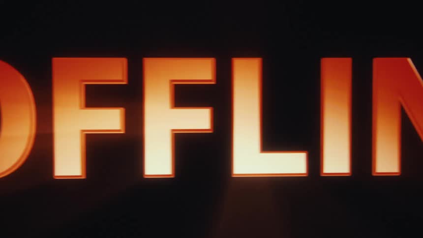 A vintage digital video shows a bright orange 3d text graphic that reads offline against a dark background