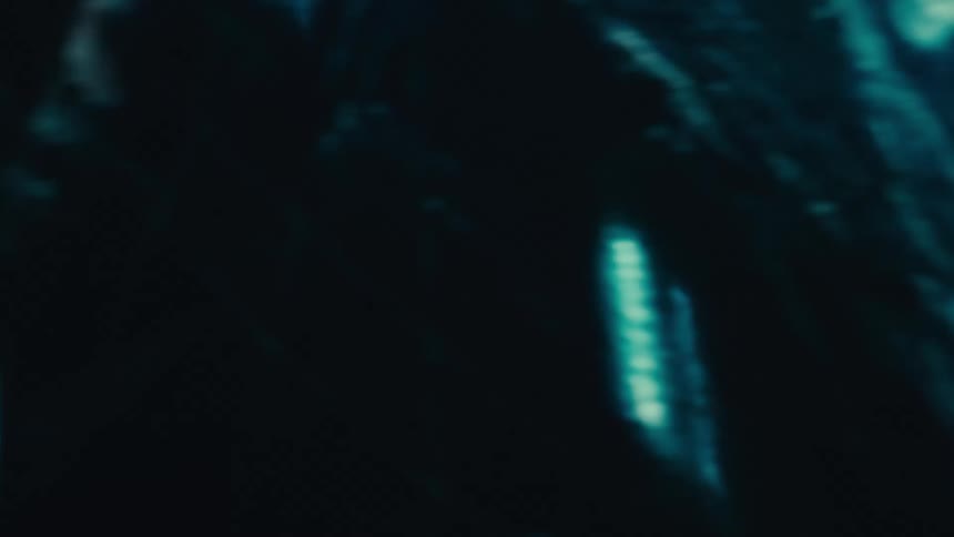 Multiple lines of light moving toward the center of the screen creating a tunnel effect