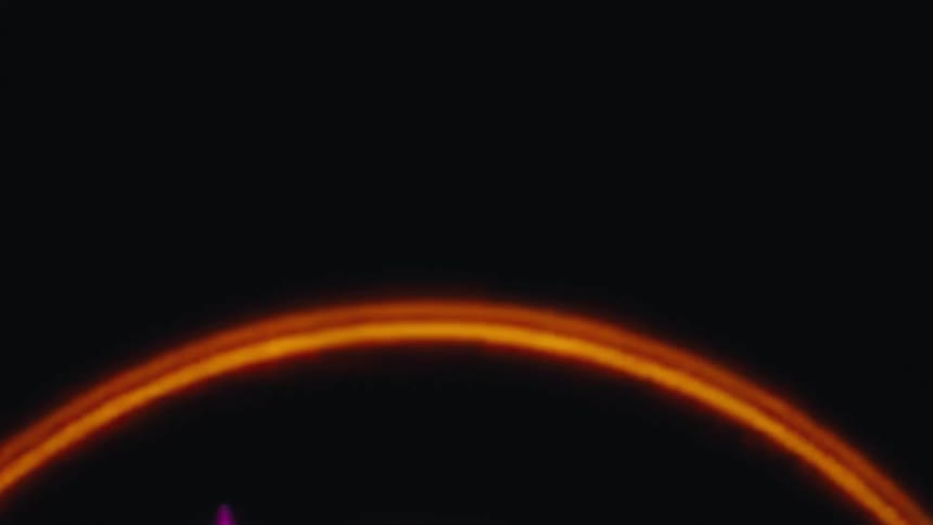 A bright glowing orange ring of fire and light slowly expands and pulsates against a completely black background