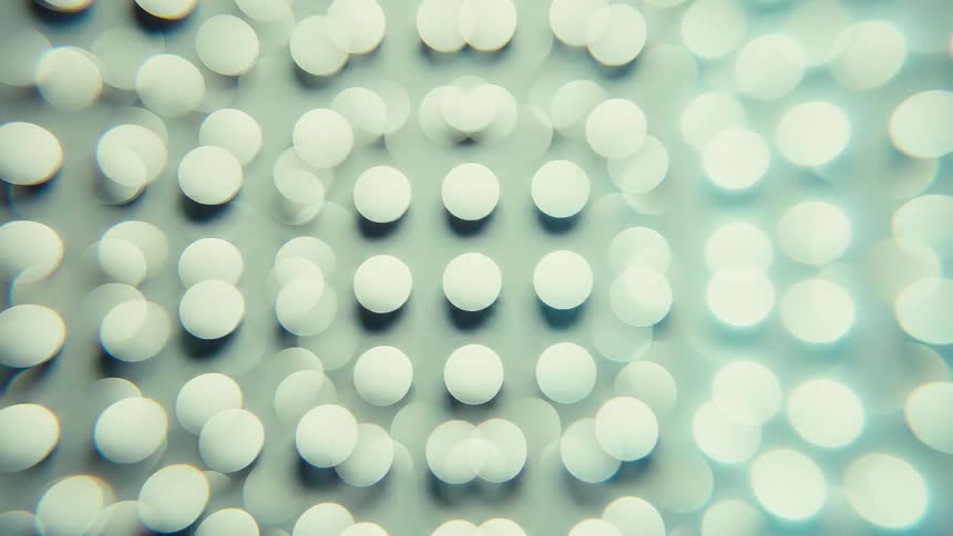 Blurred white circles arranged in a geometric pattern on a light background