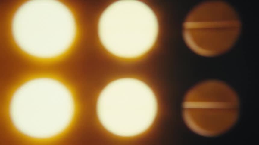 Warm lights turning on a dark background