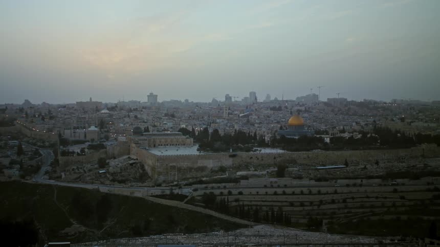 A golden dome stands out among the buildings in large city