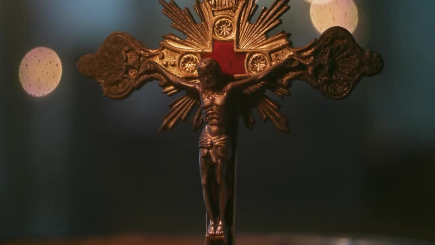 A cross sits in a dark area