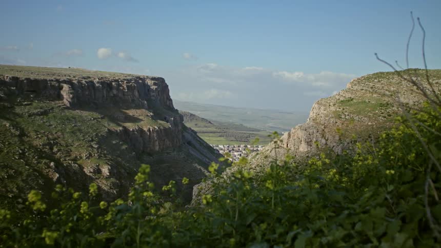 A city in a valley is seen between two mountains
