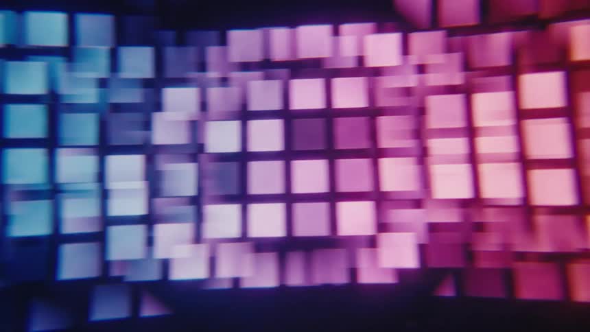 A screen shows a wall of squares that change color from purple to green to blue