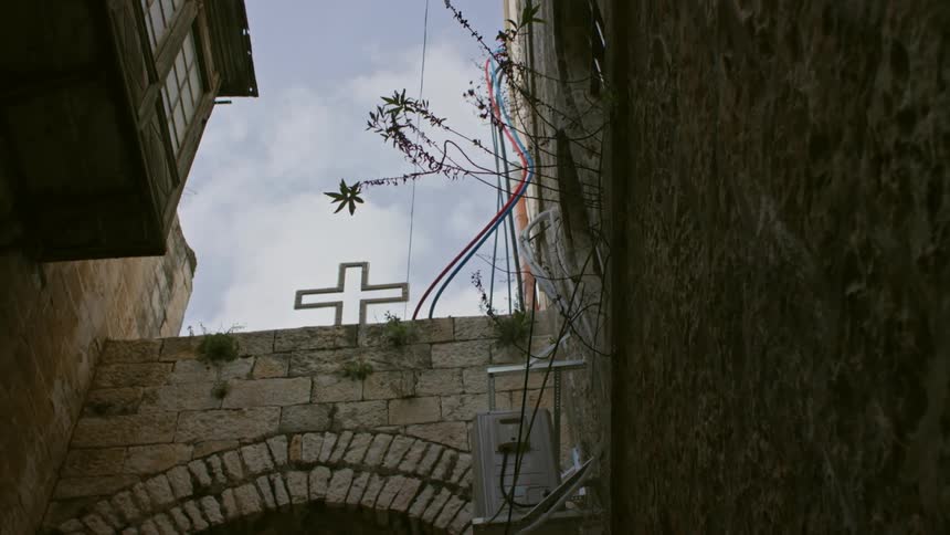 Cross over an arched walkway on a cloudy day