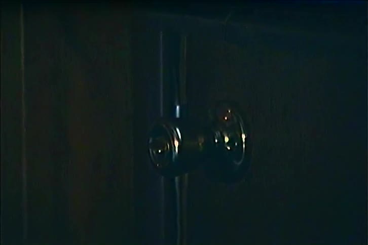 The light slowly goes out on the wooden door