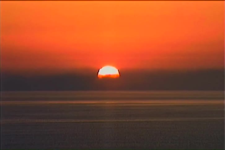 The sun is rising on ocean