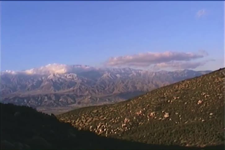 Mountains and highlands covered with sparse vegetation outdoors during daytime