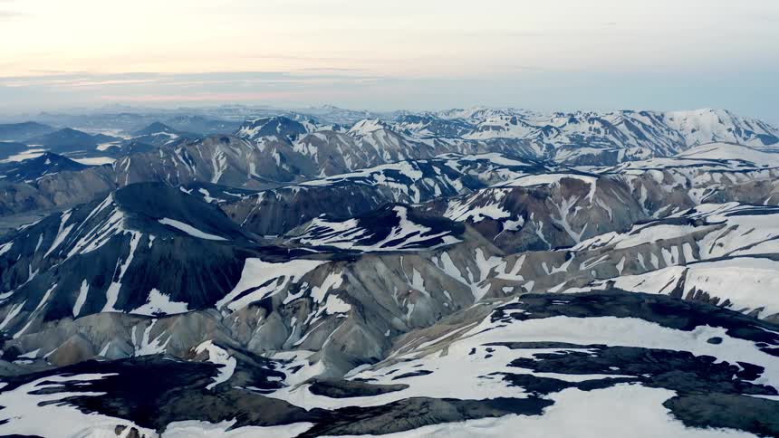 Aerial of mountains and valleys in an arctic region during daytime