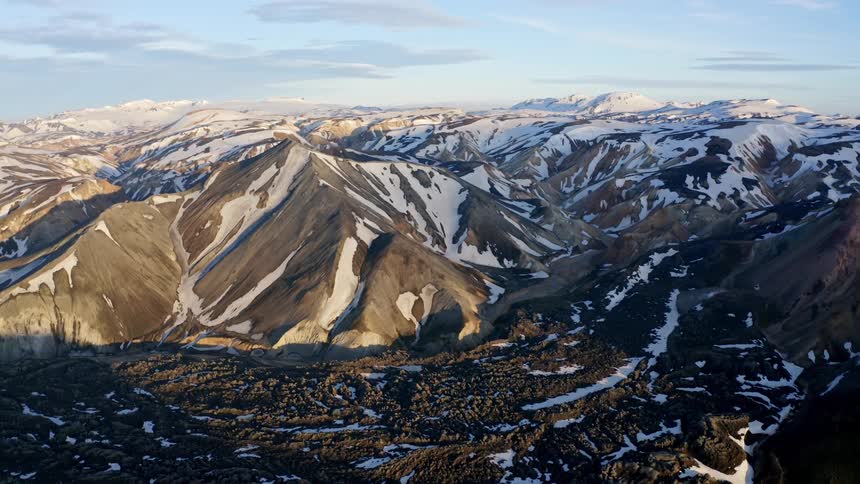 The mountains are only partially covered in snow
