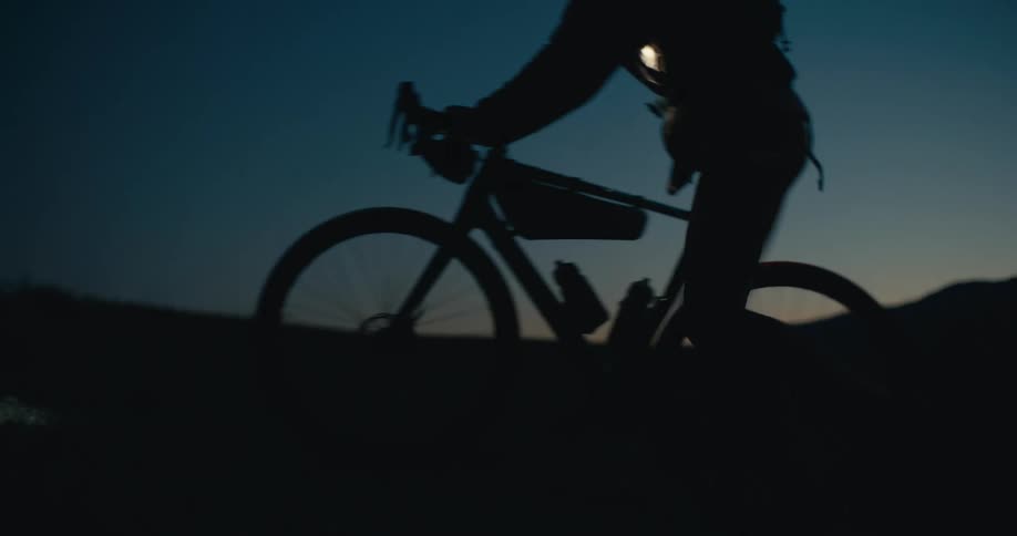 Cyclist in silhouette riding at sunset