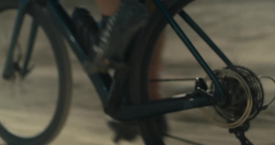Pedaling hard on a bicycle on a dirt road