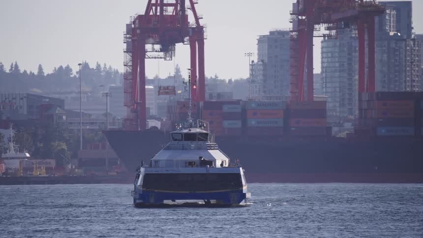 Watercraft leaves a wake while moving away from the loading docks on a foggy day