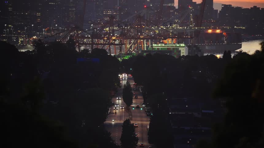 The sun sets as traffic flows into the city