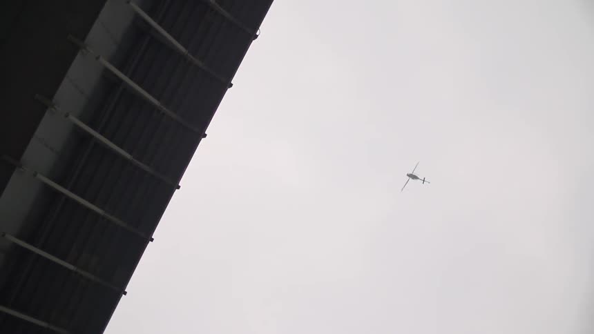 View of a cloudy sky with a helicopter flying high