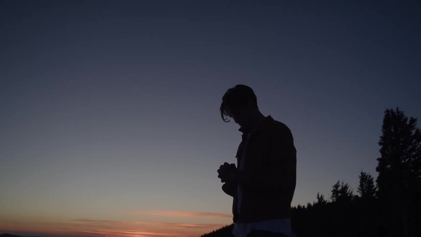 A person outside at dusk