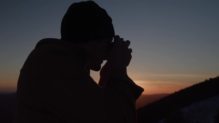 A man takes a photo outside