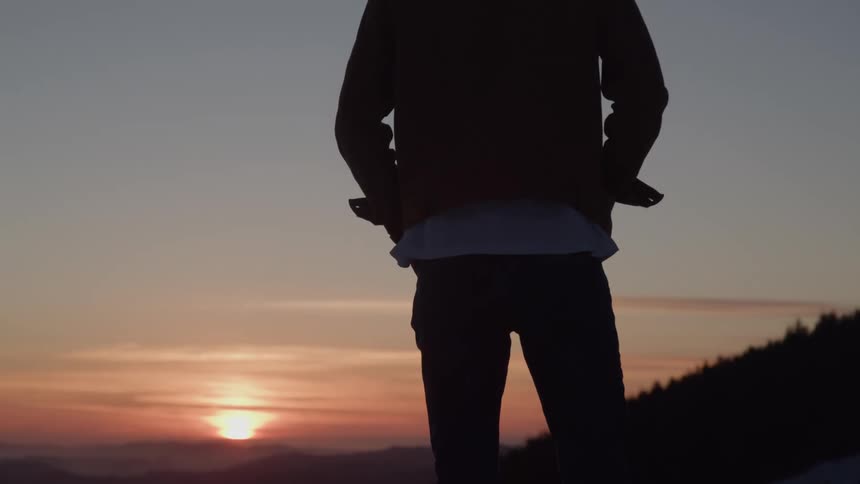 A person standing outside at dusk