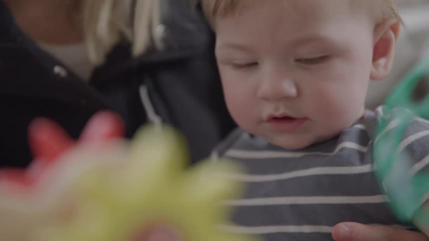 Small child putting a toy in his mouth