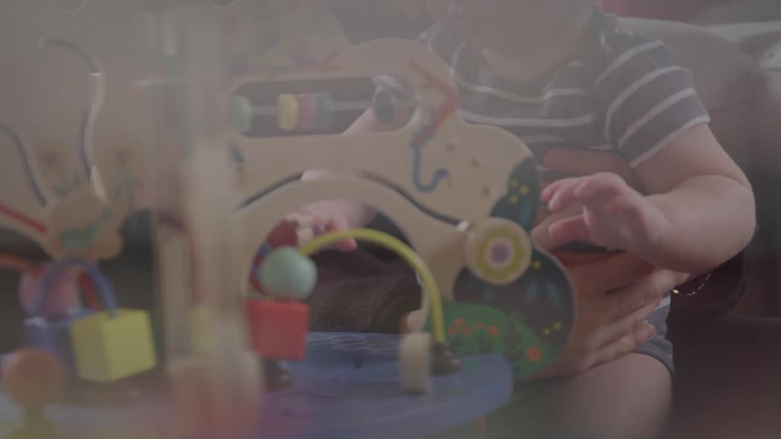 Child playing with an educational wooden toy