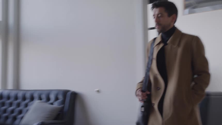 The man walks to his desk in the office