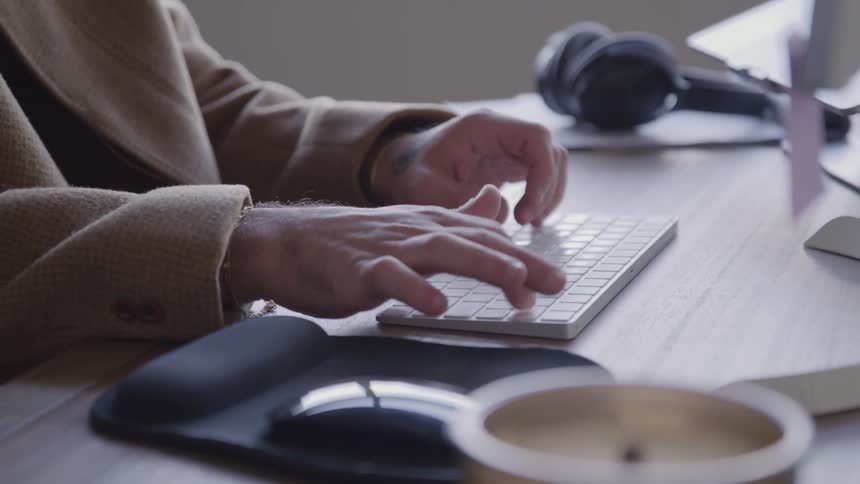The man is typing on his keyboard
