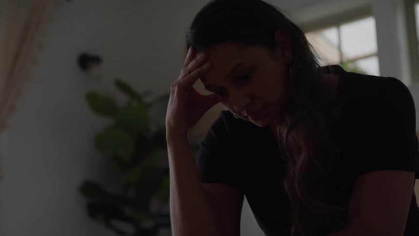 Discouraged woman with her hand on her head