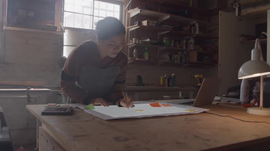 Concentrated woman drawing a project on a table
