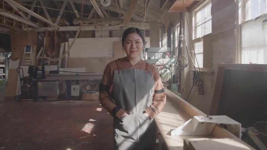 A woman standing in a workshop