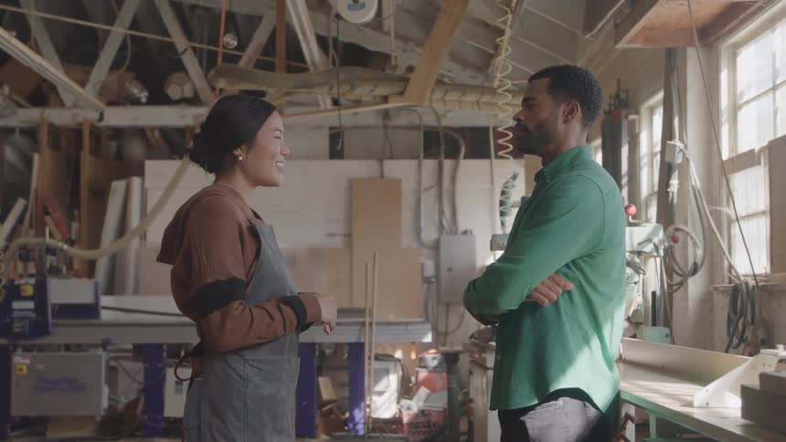 Woman and a man in a factory talking