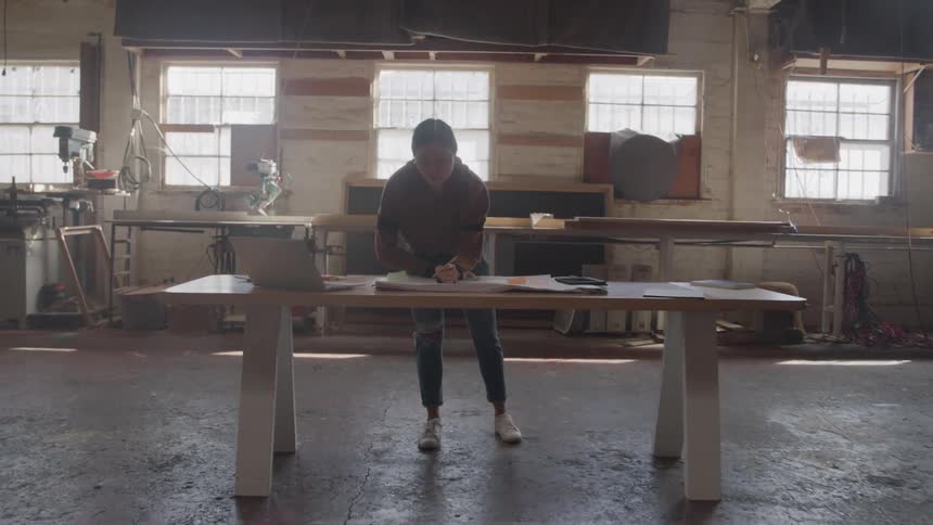 Woman standing drawing at a table