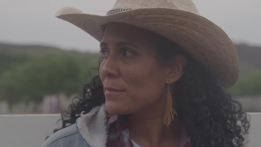 A woman wearing a cowboy hat