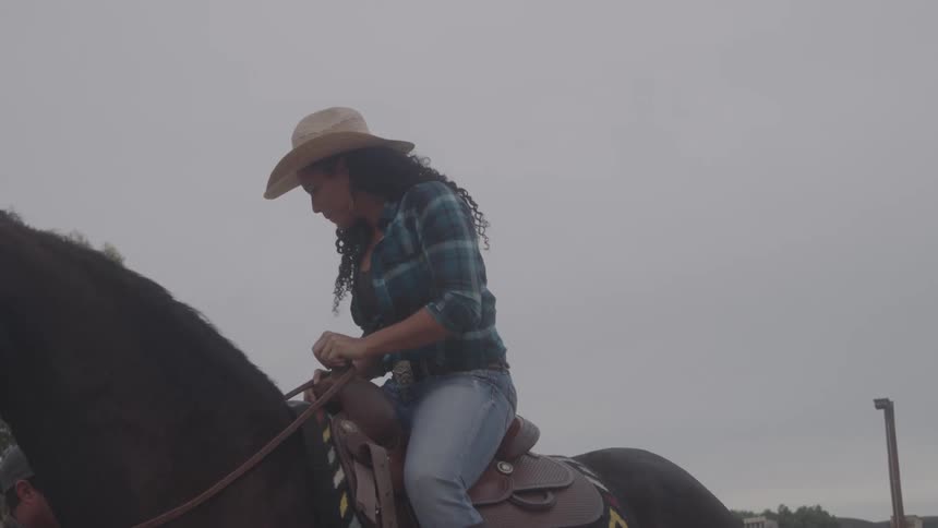 A woman riding a horse