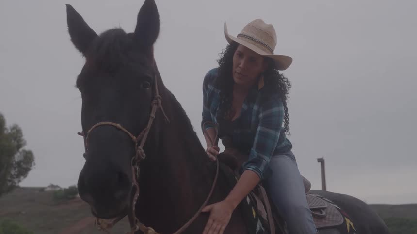 A woman sits on her horse