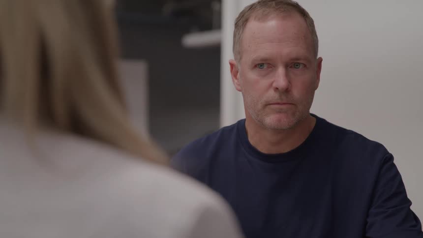Man looks seriously at the person in front of him
