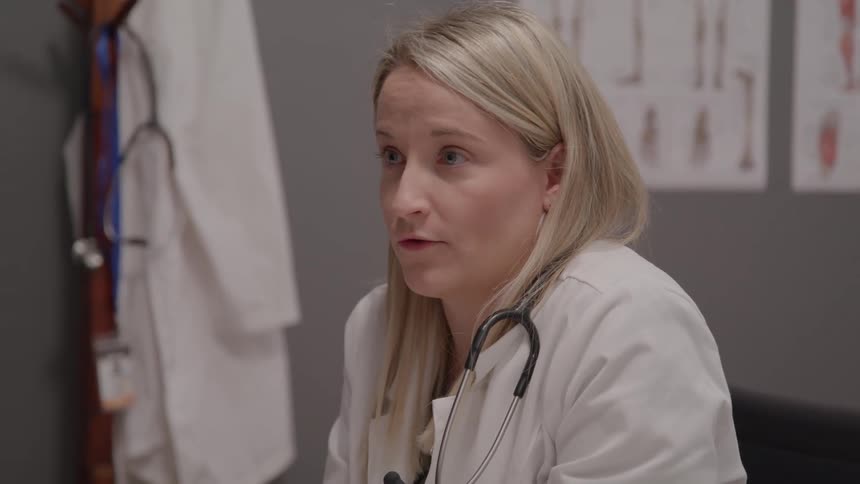 Healthcare professional in a clinical setting explaining medical information