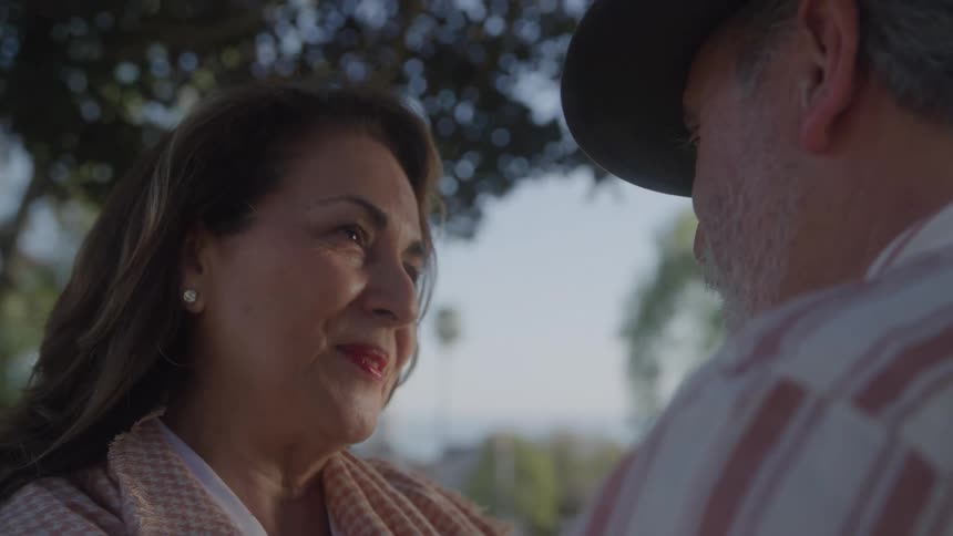 Woman smiles while looking at the man in front of her