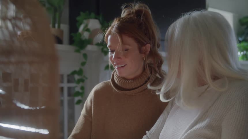 Two woman smile together