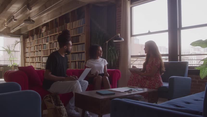 Friends talk together in the library