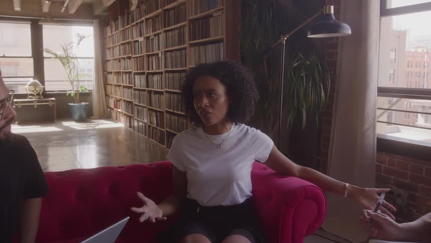 People are listening to a woman speak in the library