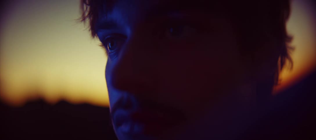 Face of a young man lit by the sunset