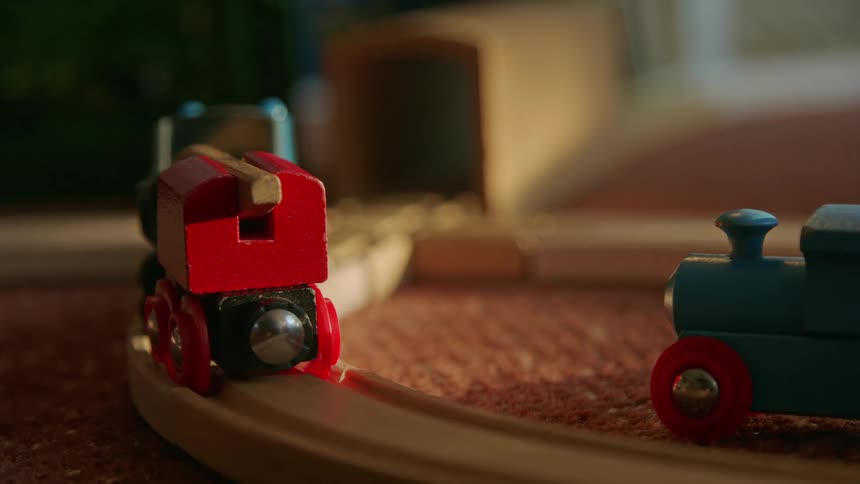 Colorful toy trains on a wooden track