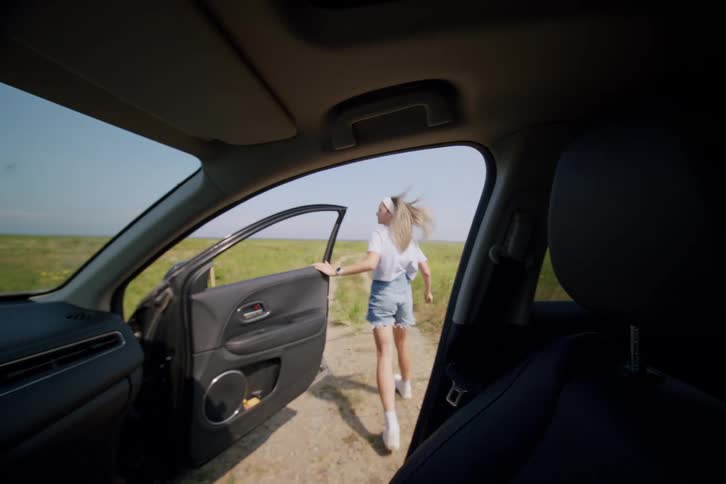 Woman gets out of the car and starts running along a dirt road