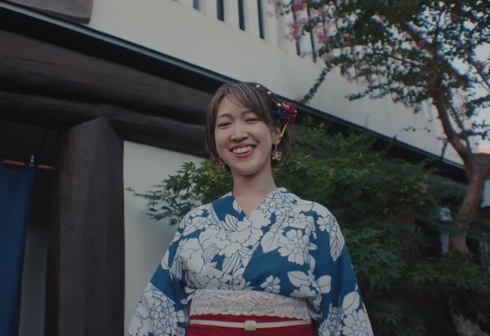 Portrait of an asian woman in Yukata is laughing in front of the building