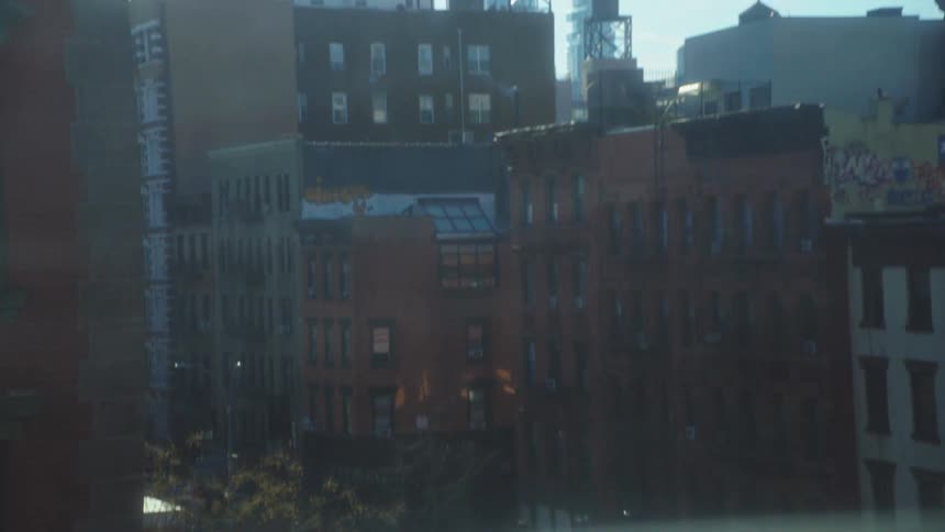 Urban landscape with buildings and water towers under a blue sky