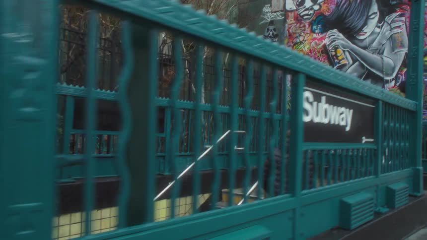 People walk through a subway terminal under the city streets during the day
