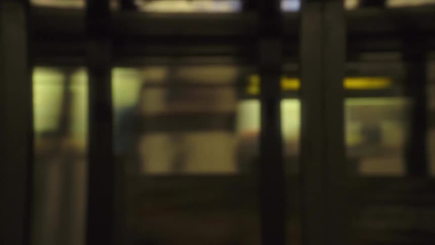Subway cars fly by to reveal another open subway car
