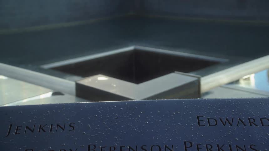 Names are etched into the plaque at the memorial fountain