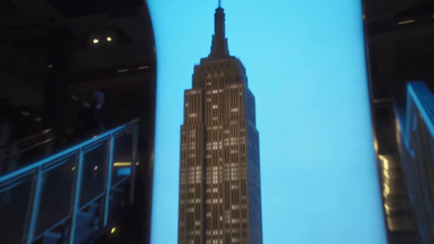 A city tower is viewed at sunset from a staircase